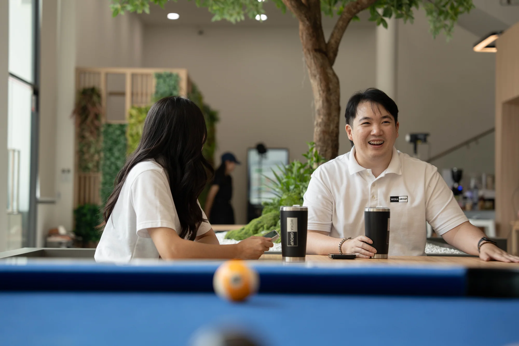 WOXA colleagues talking around a shared office table